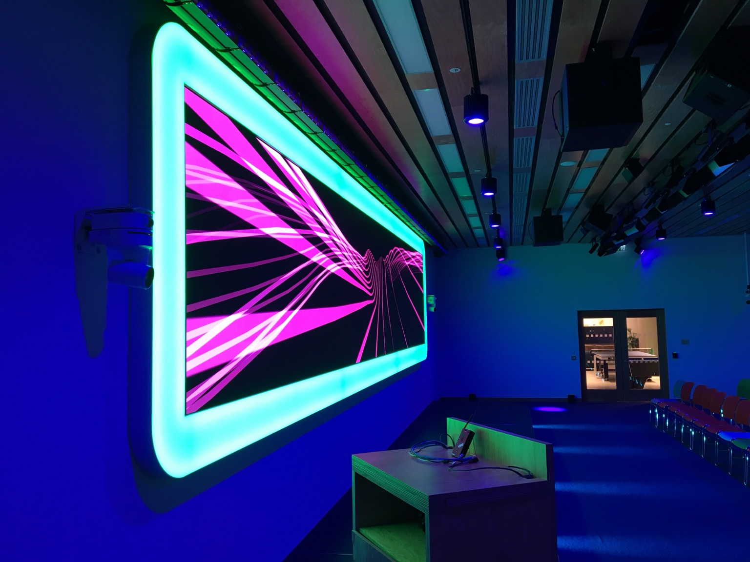 Rathbone Square event venue with an illuminated display, presentation desk and seating